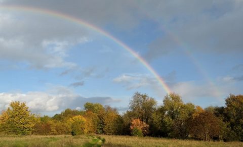 Double rainbow over village